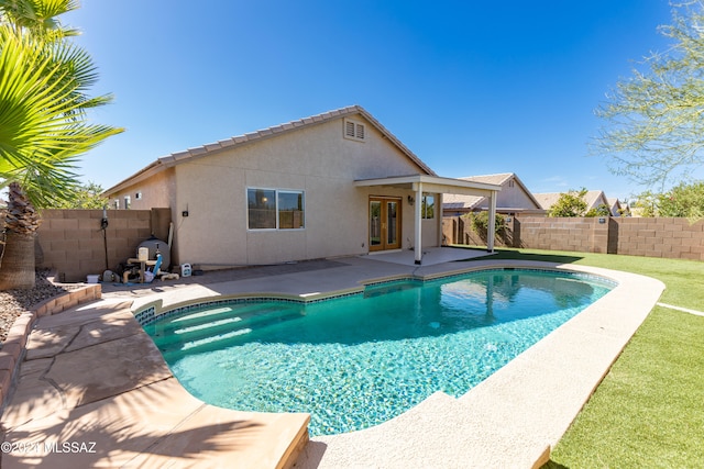 view of swimming pool with a yard and a patio area