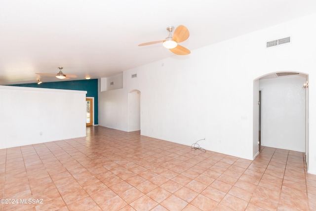 tiled spare room with ceiling fan