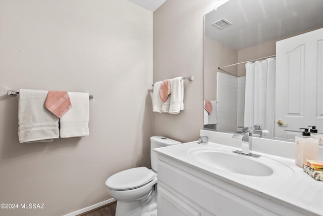 bathroom with a shower with curtain, vanity, and toilet