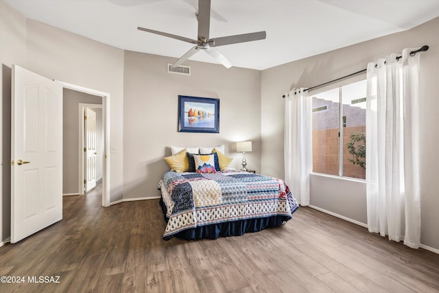 bedroom with ceiling fan and dark hardwood / wood-style floors