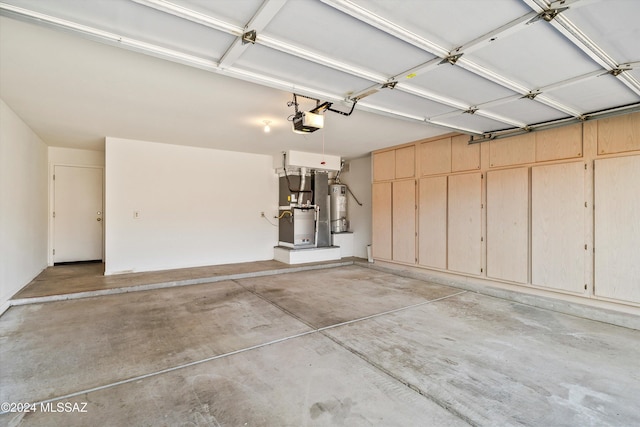 garage featuring heating unit, a garage door opener, and gas water heater