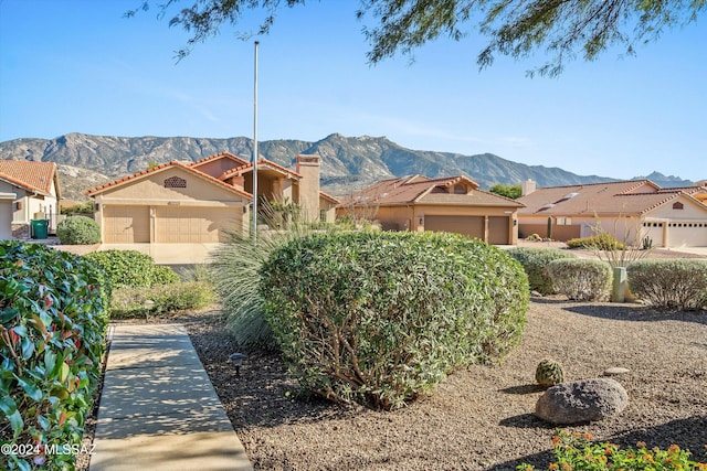 view of front facade with a mountain view and a garage