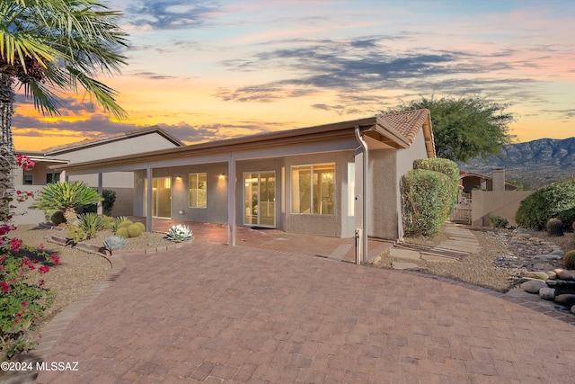 back house at dusk featuring a mountain view