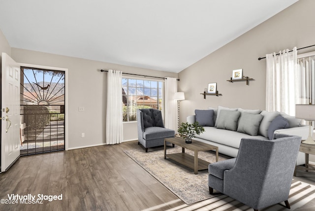 living room with hardwood / wood-style floors and vaulted ceiling