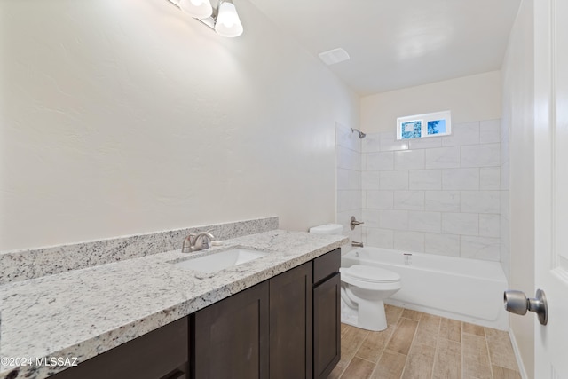 full bathroom with hardwood / wood-style floors, vanity, toilet, and tiled shower / bath