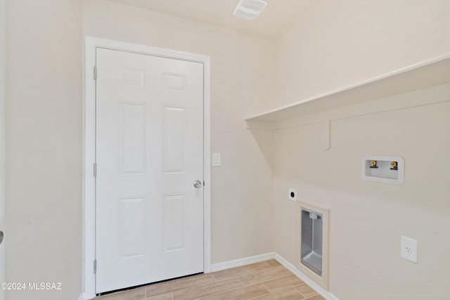 laundry area with hookup for an electric dryer, hookup for a washing machine, and light hardwood / wood-style flooring