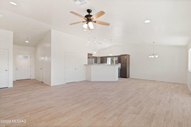 unfurnished living room featuring ceiling fan with notable chandelier, light hardwood / wood-style floors, and vaulted ceiling