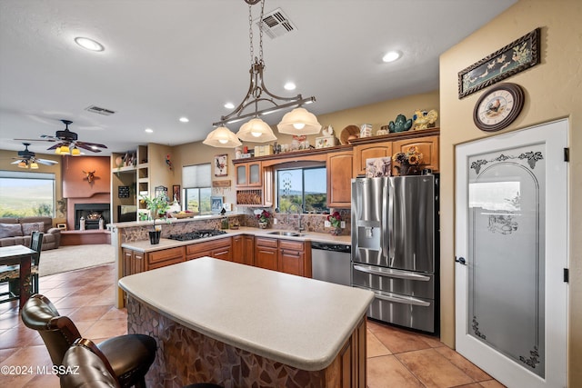 19931 S Sterling Ave, Mammoth, AZ 85618 - kitchen featuring sink, hanging light fixtures, stainless steel appliances, kitchen peninsula, and a kitchen island