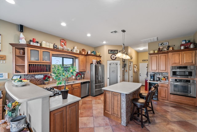 19931 S Sterling Ave, Mammoth, AZ 85618 - kitchen featuring a kitchen breakfast bar, backsplash, stainless steel appliances, pendant lighting, and a kitchen island