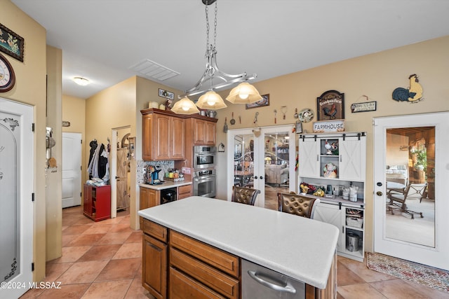 19931 S Sterling Ave, Mammoth, AZ 85618 - kitchen featuring hanging light fixtures, stainless steel double oven, light tile patterned floors, wine cooler, and a kitchen island