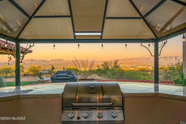 19931 S Sterling Ave, Mammoth, AZ 85618 - patio terrace at dusk featuring a mountain view, a gazebo, and a grill