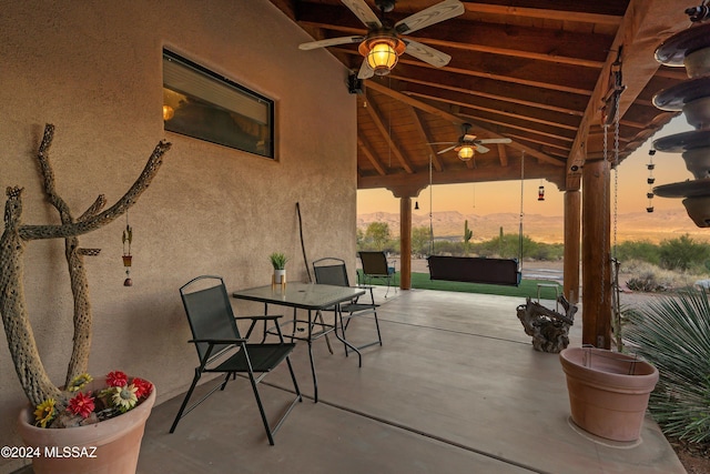 19931 S Sterling Ave, Mammoth, AZ 85618 - patio terrace at dusk featuring ceiling fan and a mountain view