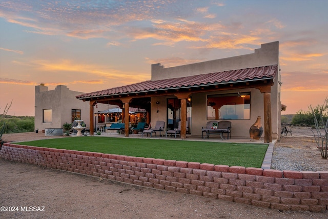 19931 S Sterling Ave, Mammoth, AZ 85618 - back house at dusk featuring a patio area and a yard
