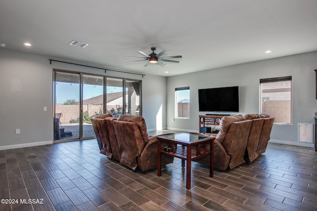 living room with ceiling fan and dark hardwood / wood-style flooring