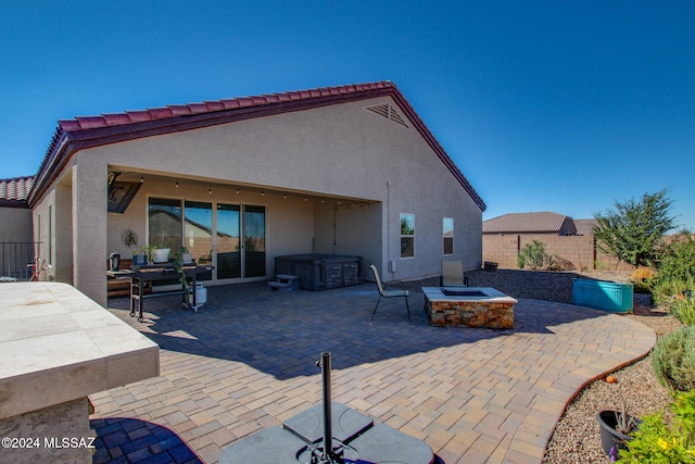 back of house featuring a patio and an outdoor fire pit