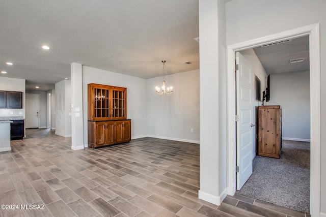 unfurnished living room with light hardwood / wood-style floors and an inviting chandelier