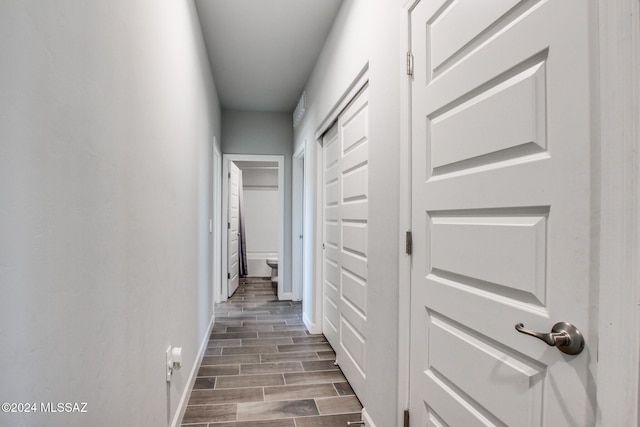 hallway with hardwood / wood-style flooring