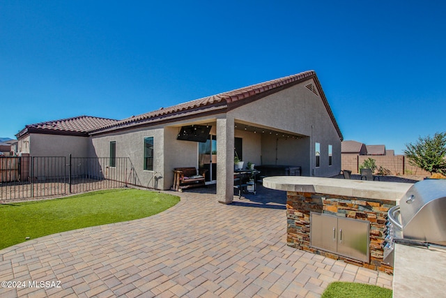 view of patio featuring an outdoor kitchen