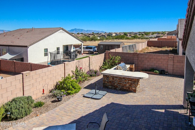 view of patio / terrace featuring a mountain view and a fire pit