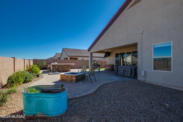 view of yard featuring an outdoor fire pit and a patio