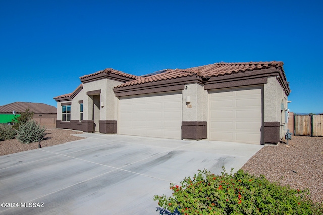 mediterranean / spanish house featuring a garage