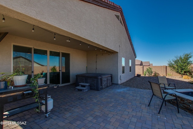 view of patio / terrace with a hot tub