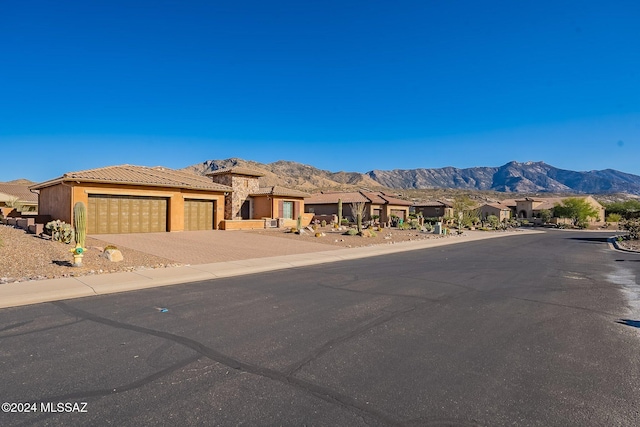 view of front of house with a mountain view and a garage