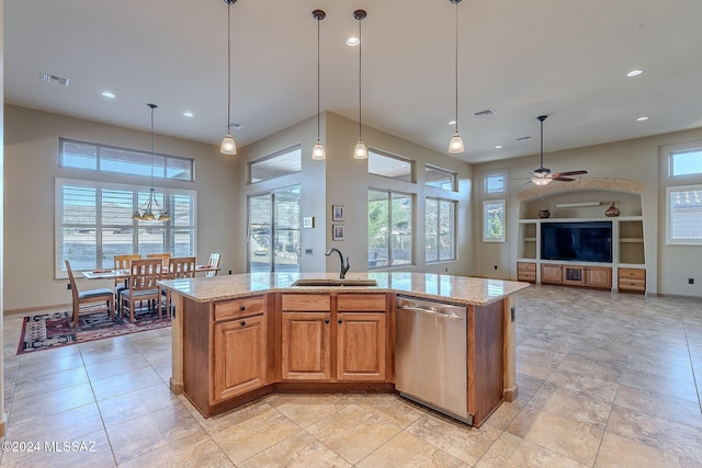 kitchen featuring dishwasher, an island with sink, and a healthy amount of sunlight