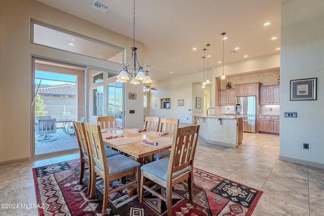 dining space featuring a notable chandelier and sink