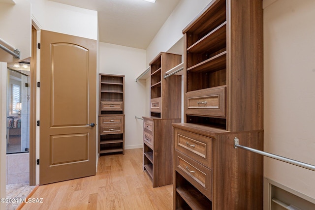 spacious closet featuring light hardwood / wood-style floors