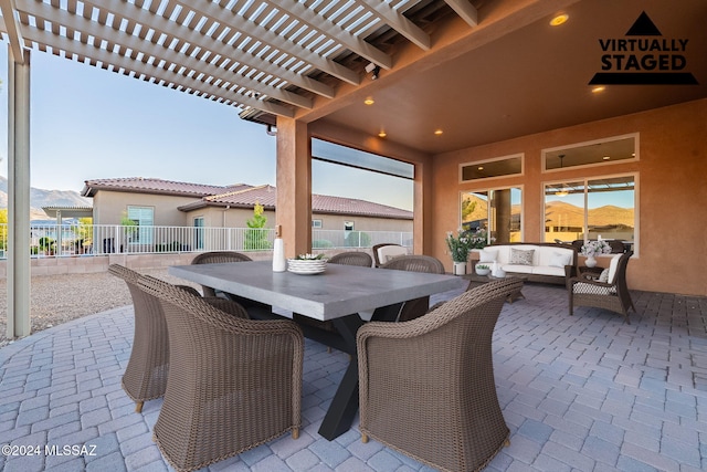 view of patio / terrace featuring an outdoor living space, a mountain view, and a pergola