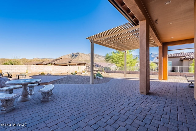 view of patio with a pergola and a mountain view