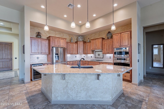 kitchen with sink, a breakfast bar area, a large island, stainless steel appliances, and beverage cooler