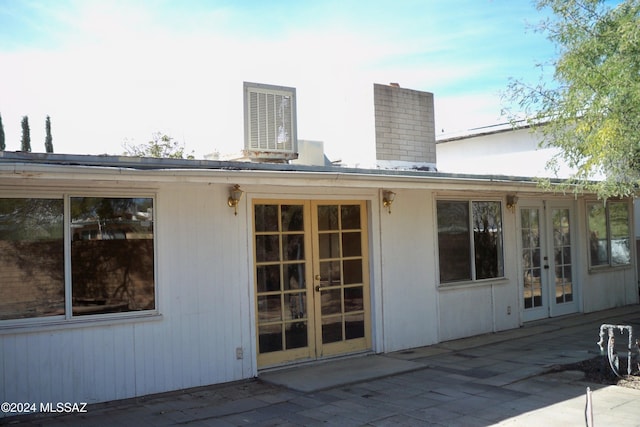 back of property featuring french doors, a patio, and central AC unit