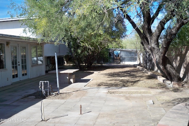 view of yard featuring french doors and a patio area