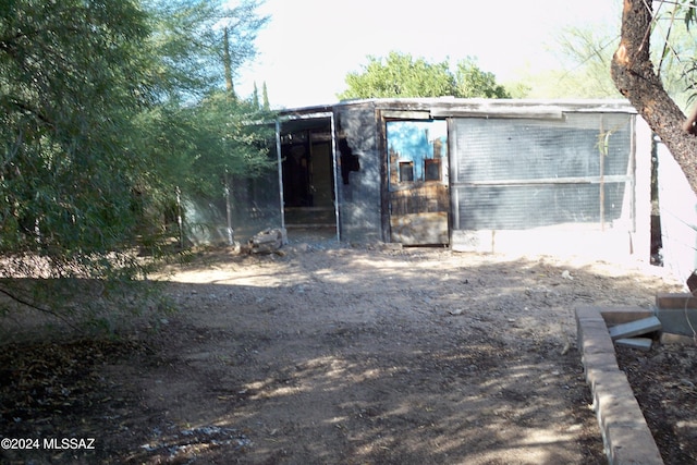 back of house featuring an outbuilding