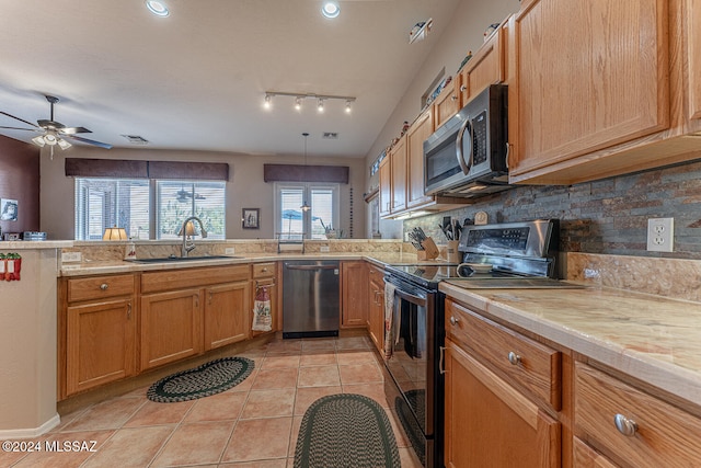 kitchen with tasteful backsplash, light tile patterned floors, sink, pendant lighting, and stainless steel appliances