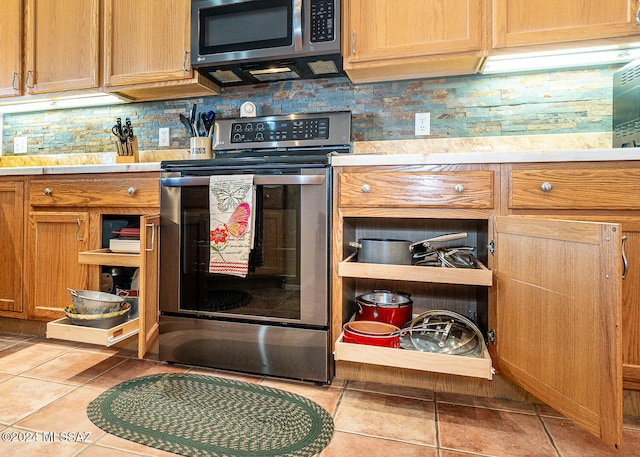 kitchen with light tile patterned flooring and stainless steel appliances