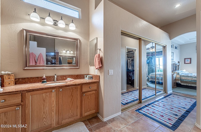 bathroom featuring vanity, ceiling fan, and tile patterned flooring