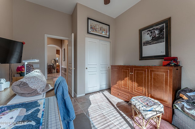 bedroom with a closet and light tile patterned flooring