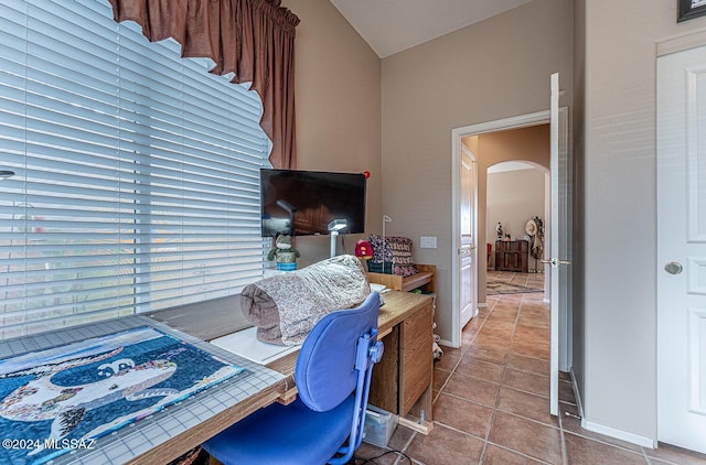 tiled office space with vaulted ceiling