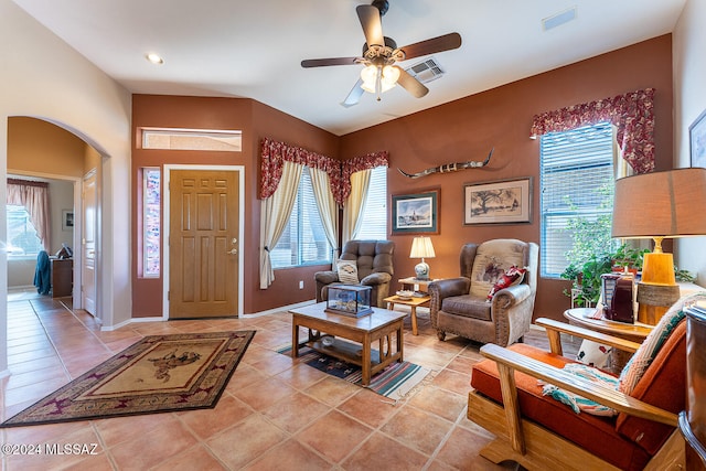 tiled living room with ceiling fan