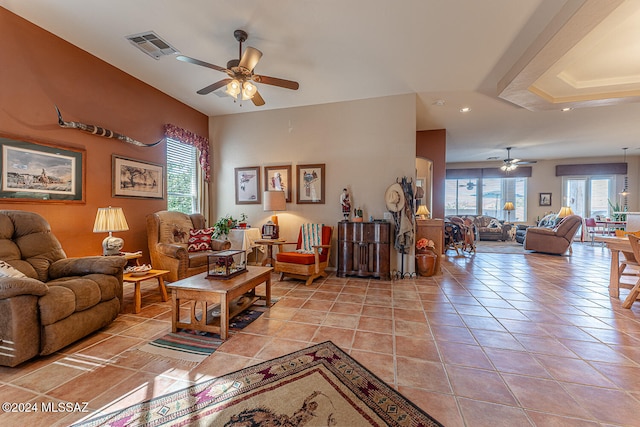 living room featuring ceiling fan and light tile patterned flooring