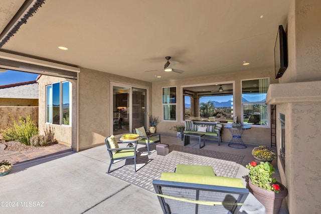 view of patio / terrace with ceiling fan and an outdoor living space