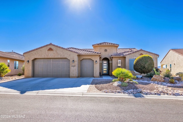 mediterranean / spanish home featuring a garage