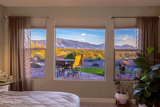 bedroom featuring multiple windows and a mountain view