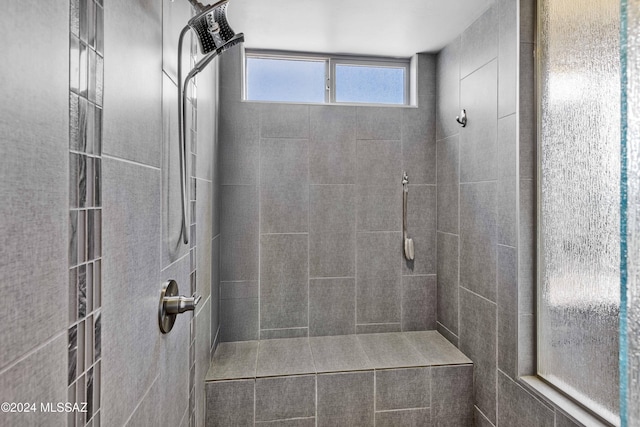 bathroom with a tile shower