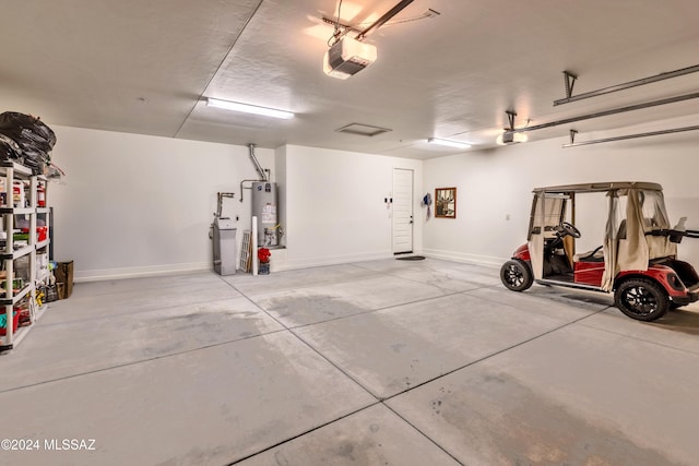 garage featuring gas water heater and a garage door opener