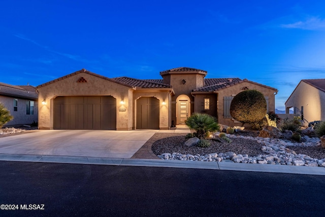 mediterranean / spanish house with a garage