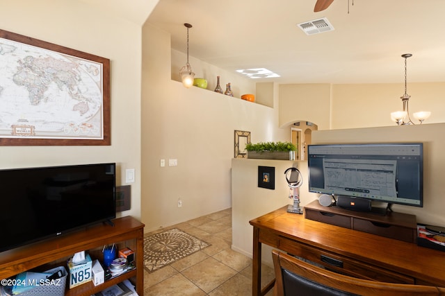 office space with light tile patterned flooring and ceiling fan with notable chandelier